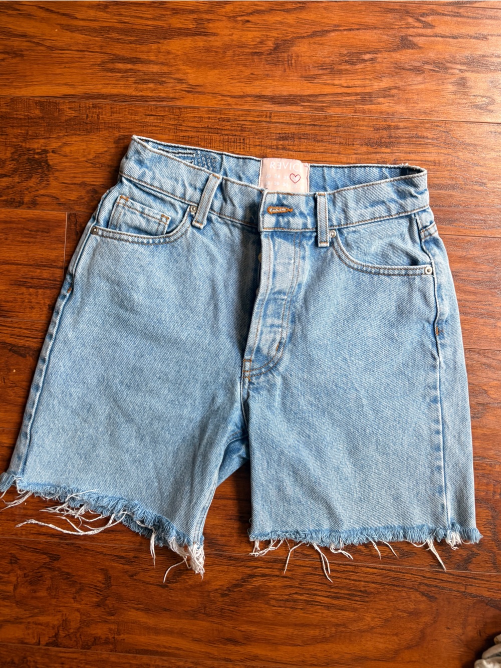 Revive high rise button fly raw hem shorts